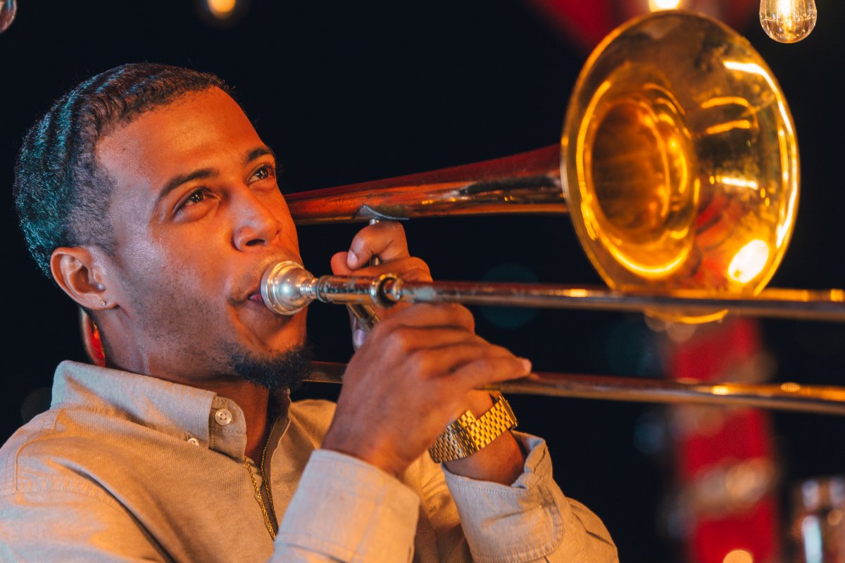 Trombone player performing live on stage.